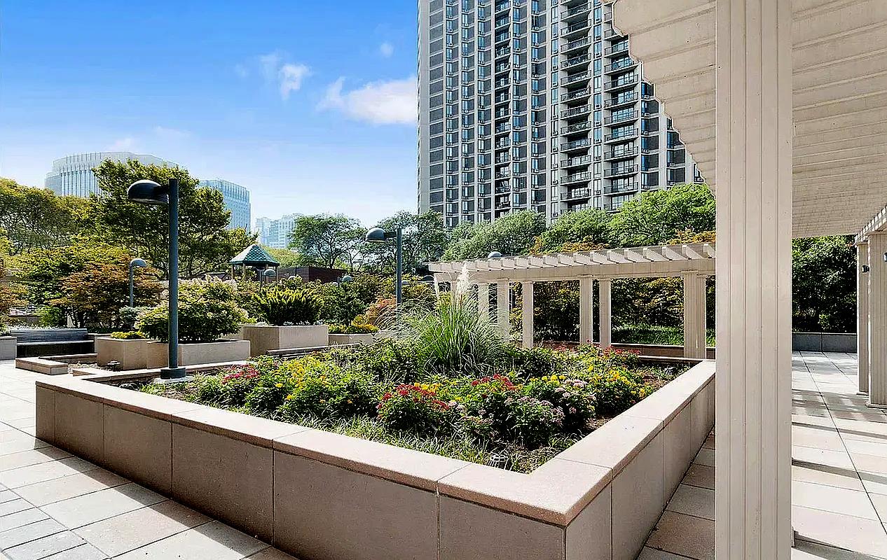 75 Henry Street, Unit 14C Brooklyn, NY 11201 - Photo 12 of 17 a view of a balcony with potted plants and palm trees