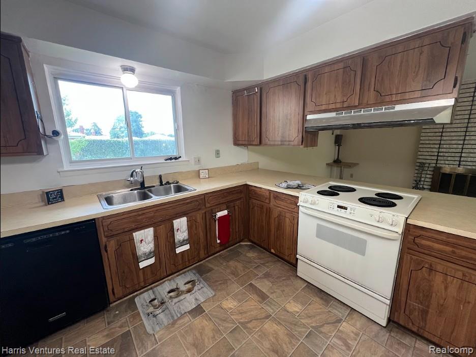 28482 Sutherland Avenue Warren, MI 48088 - Photo 8 of 25 Kitchen featuring wood-finish cabinetry, light-toned countertops, and a dual-basin stainless steel sink