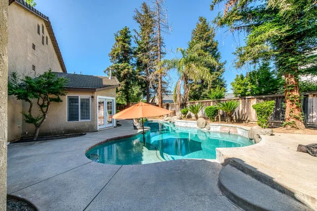 a view of a patio with couches and a fire pit