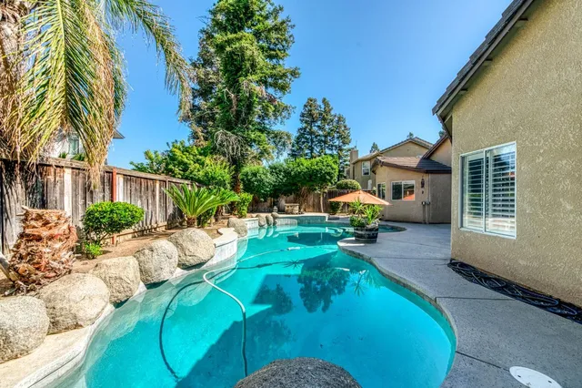 a backyard of a house with yard and outdoor seating