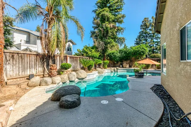 an empty room with a empty space and chandelier fan