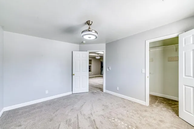 a bathroom with a double vanity sink a mirror a bathtub and window