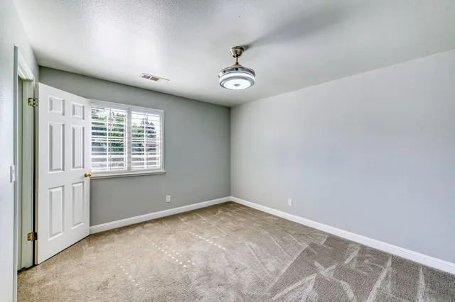 a view of a livingroom with a fireplace and a window