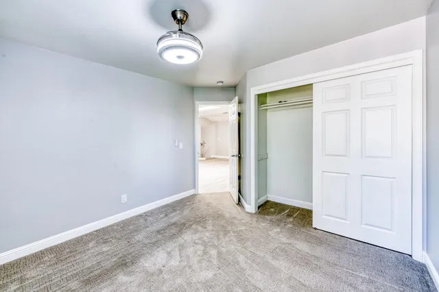 an empty room with a empty space and a ceiling fan