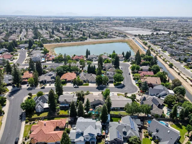 an aerial view of a house with a yard and garden