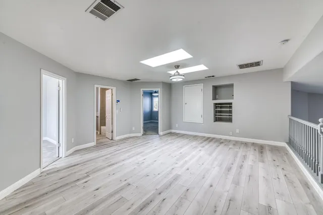 a bathroom with a granite countertop sink a toilet and a mirror