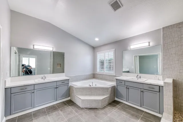 a view of an empty room with a fireplace and a window