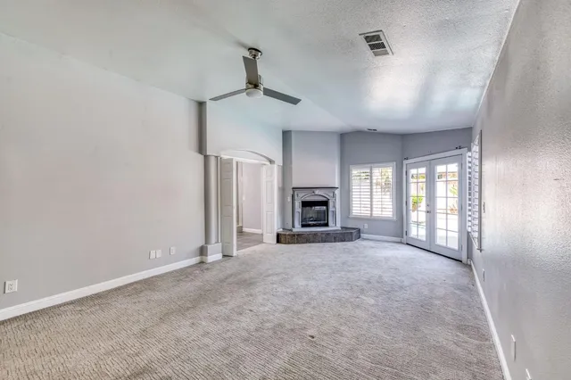 a view of empty room with a fireplace