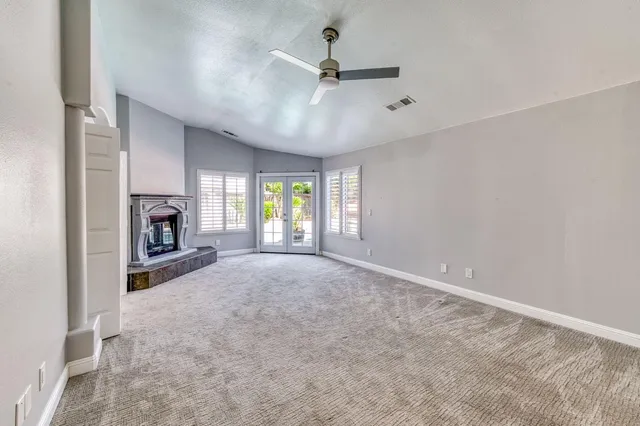 a kitchen with stainless steel appliances white cabinets and a large window