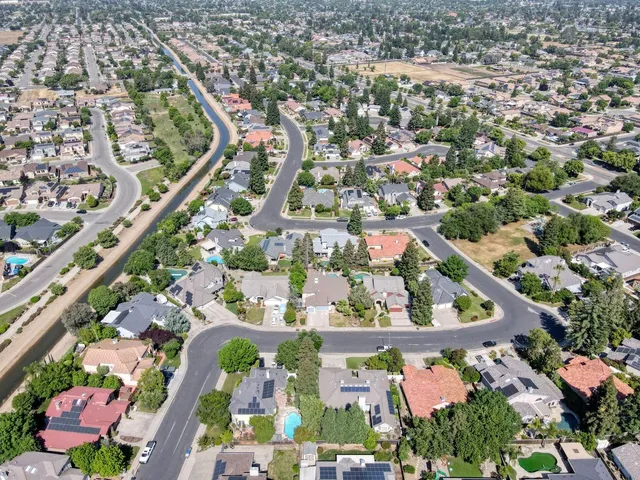 an aerial view of a house with a yard and garden