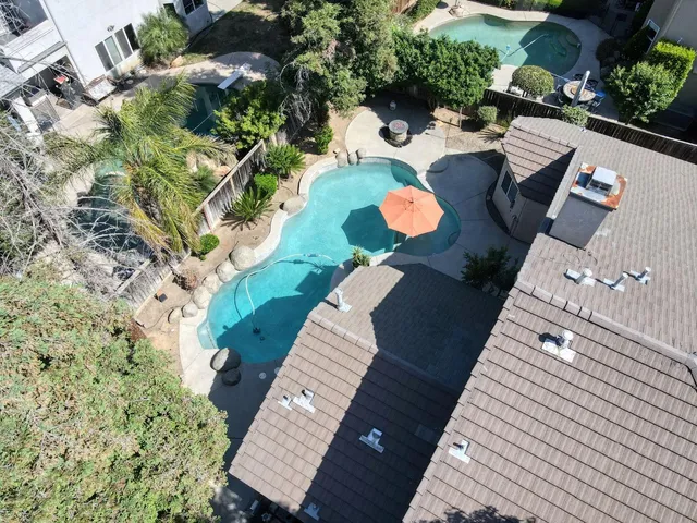 swimming pool with outdoor seating and yard