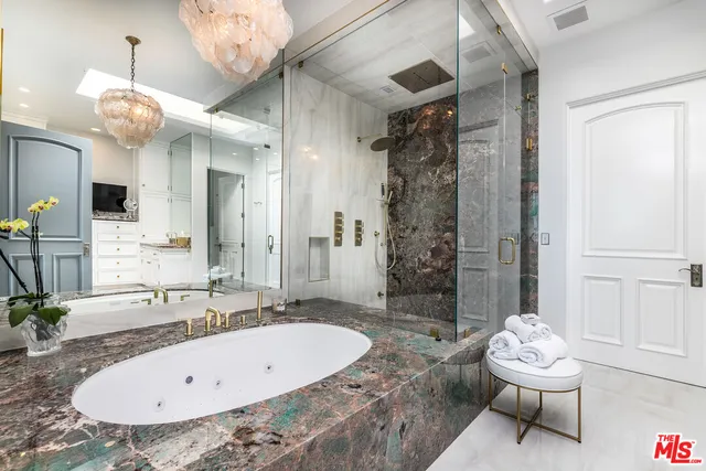 a kitchen with granite countertop white cabinets and stainless steel appliances
