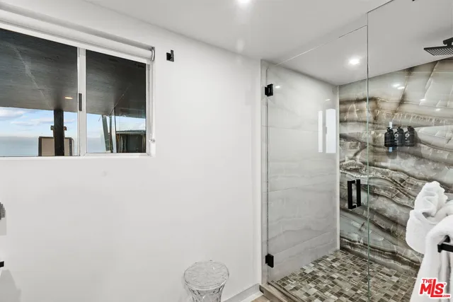 a kitchen that has a sink and a stove with wooden floor