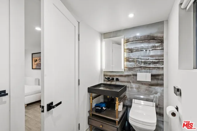 a bedroom with a bed and a large mirror