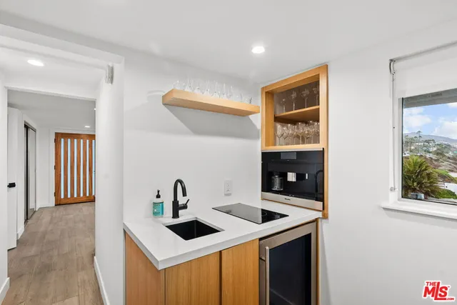 a large bed sitting in a bedroom next to a lamp