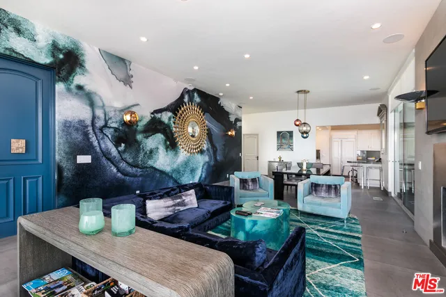 a living room with furniture and a chandelier