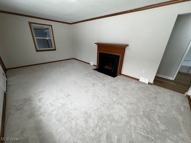 6606 Crossview Road Independence, OH 44131 - Photo 5 of 17 Unfurnished living room with a fireplace with flush hearth, ornamental molding, and carpet floors