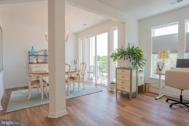 a living room with furniture and a table with wooden floor