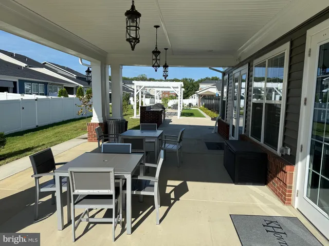 a view of a dining room with furniture wooden floor and chandelier