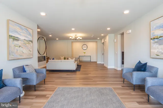 a living room with furniture and a glass door