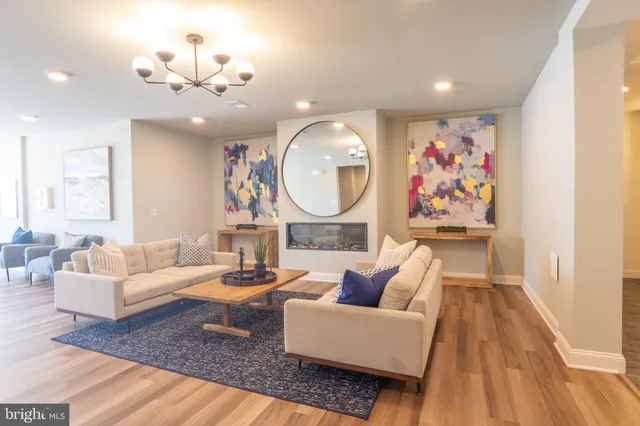 a living room with furniture and a chandelier