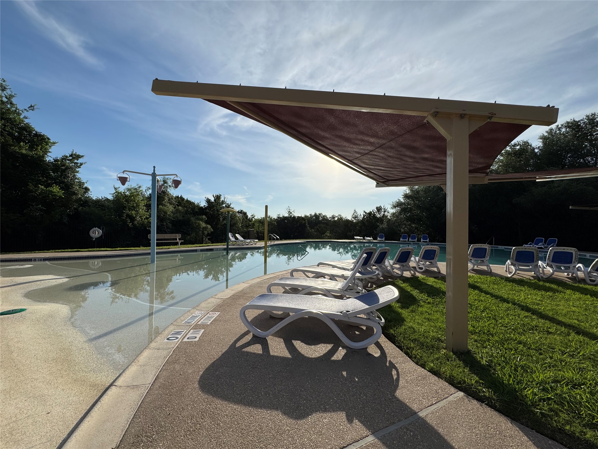 112 Eagle Owl Loop Leander, TX 78641 - Photo 32 of 34 Shaded area and lounge chairs surround the HOA pool.