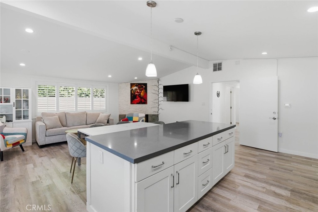 301 West Ashby Street Azusa, CA 91702 - Photo 24 of 75 a kitchen with stainless steel appliances granite countertop a sink and a living room view
