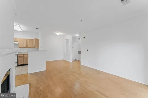 a view of a kitchen with white cabinets