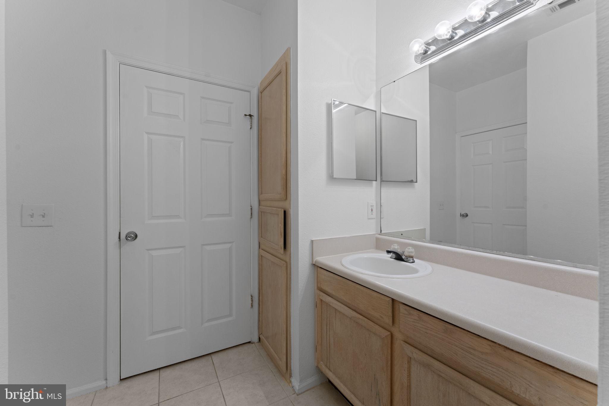 1591 Spring Gate Dr., Unit 3314 McLean, VA 22102 - Photo 16 of 56 a bathroom with a sink and a mirror