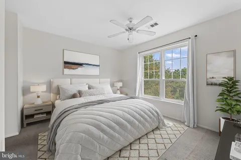 a bedroom with a large bed and a window