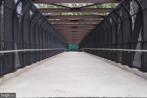 a aerial view of a brick building next to a yard
