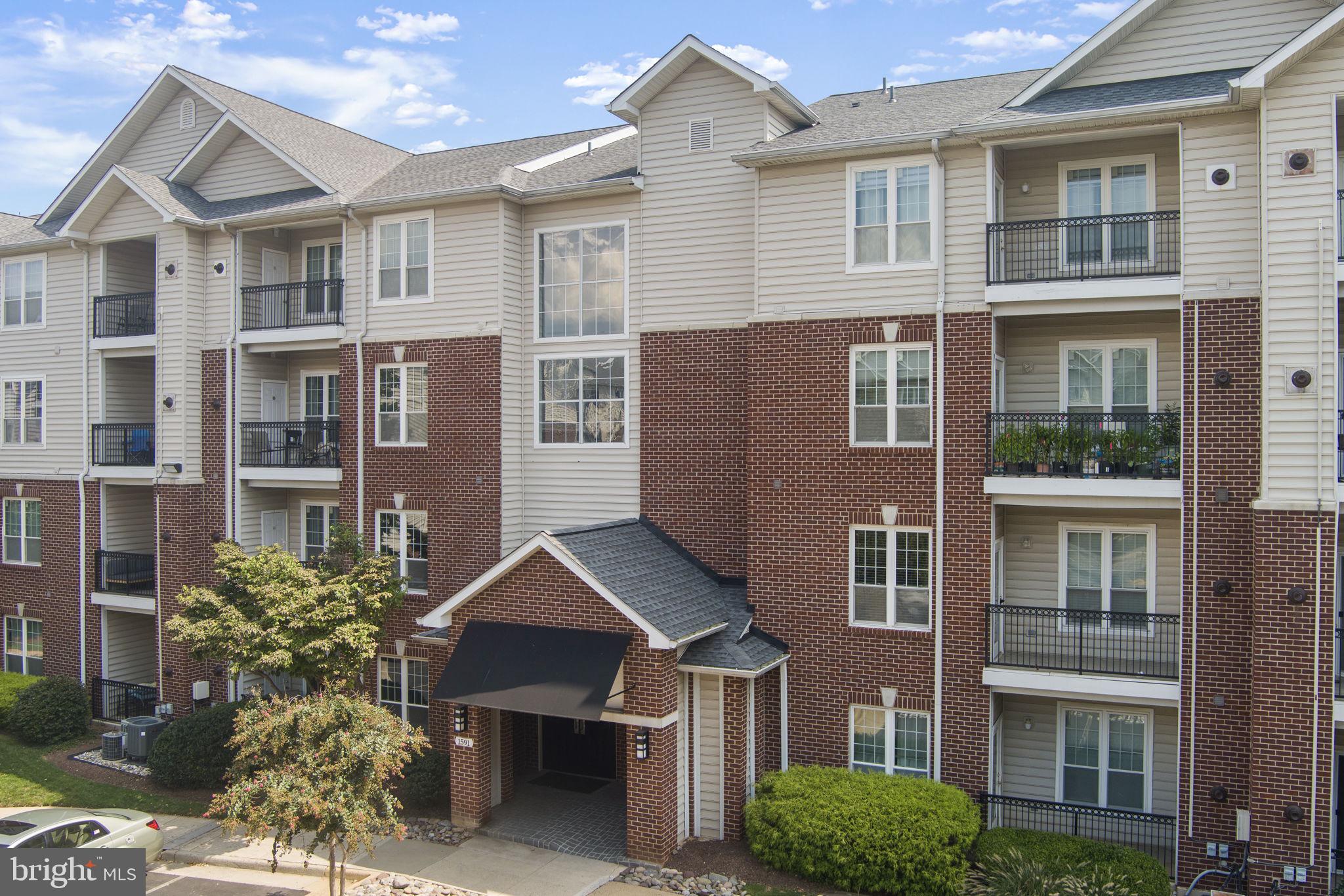 1591 Spring Gate Dr., Unit 3314 McLean, VA 22102 - Photo 46 of 56 a front view of a house with a garden