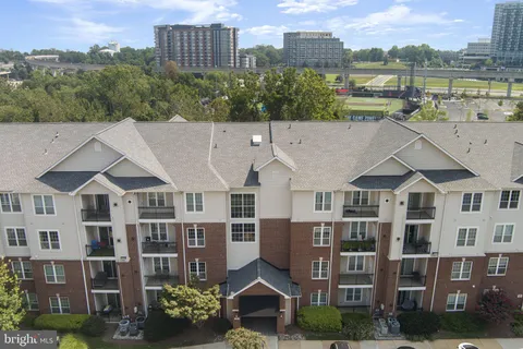 a view of a a dining room with furniture window and wooden floor