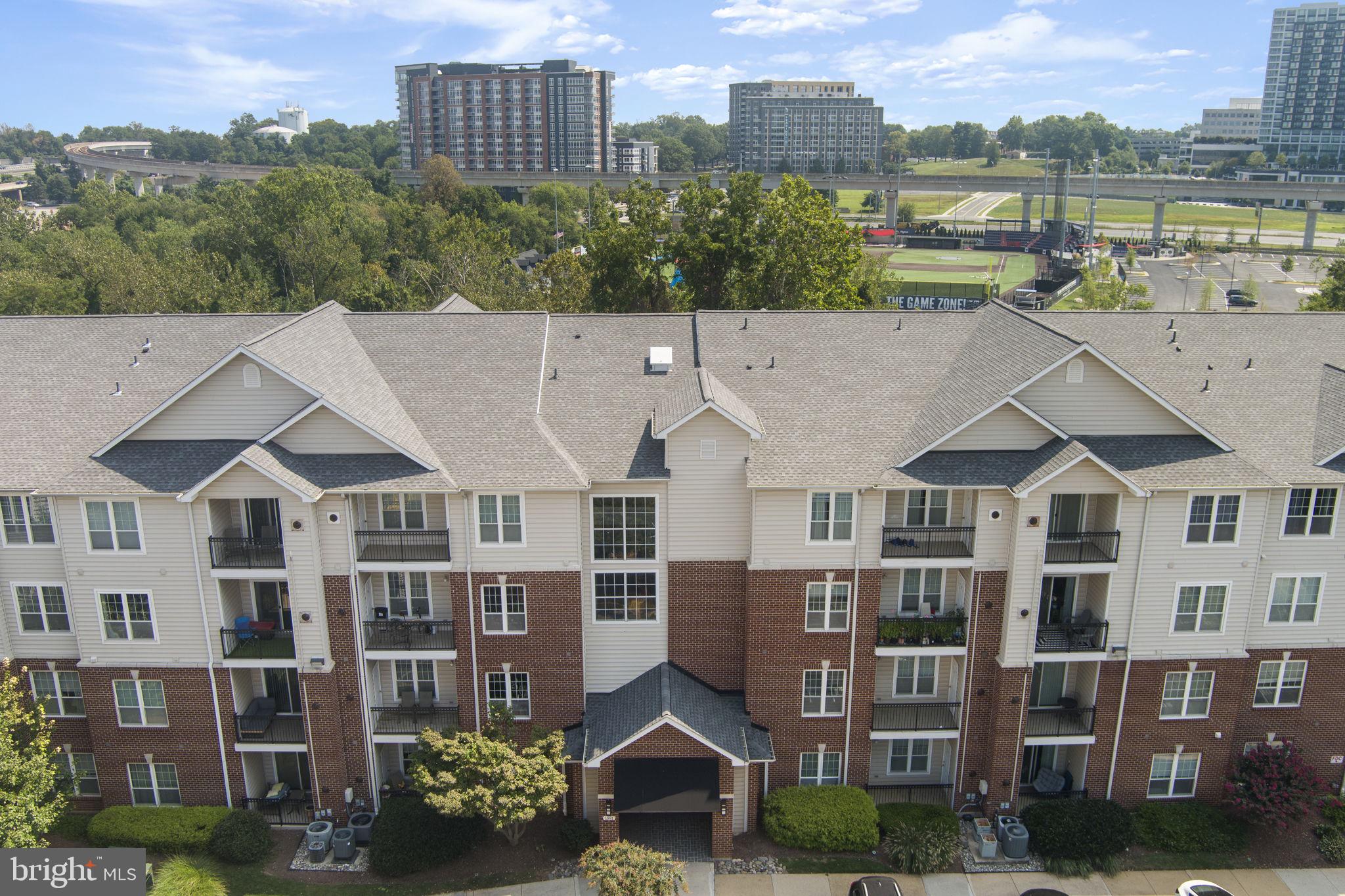 1591 Spring Gate Dr., Unit 3314 McLean, VA 22102 - Photo 47 of 56 a aerial view of a brick building next to a yard