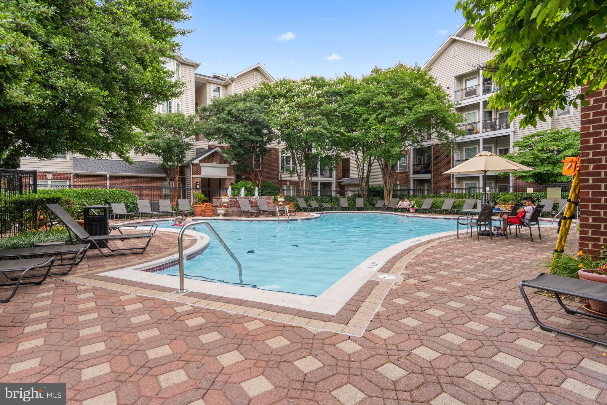 1591 Spring Gate Dr., Unit 3314 McLean, VA 22102 - Photo 49 of 56 a view of a park with swings and slides