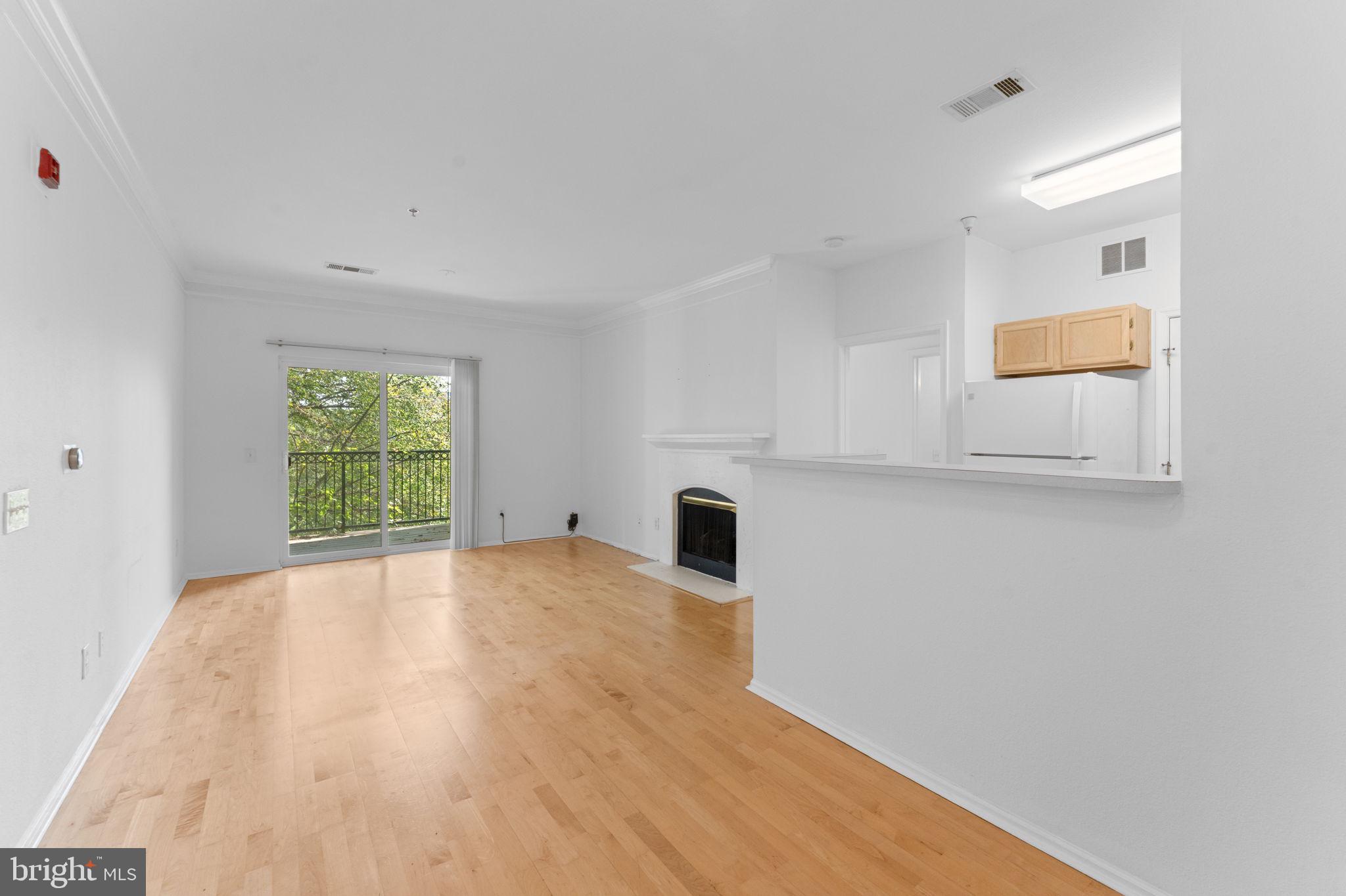 1591 Spring Gate Dr., Unit 3314 McLean, VA 22102 - Photo 10 of 56 a view of empty room with wooden floor and fan