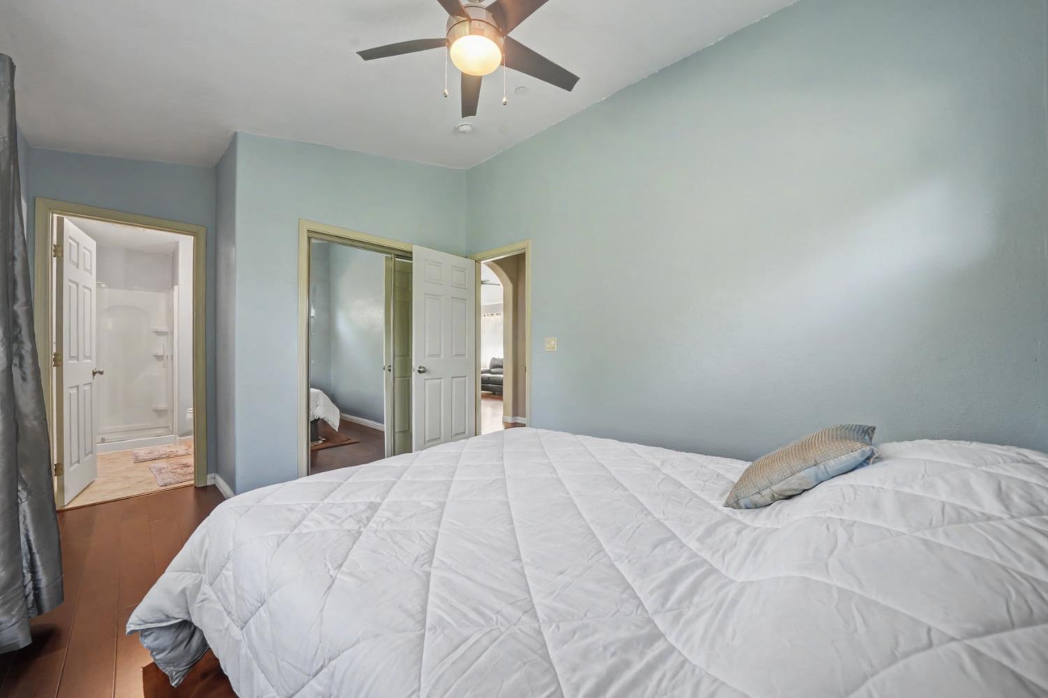 12900 New York Ranch Road Jackson, CA 95642 - Photo 16 of 31 a bedroom with a large bed and a chandelier