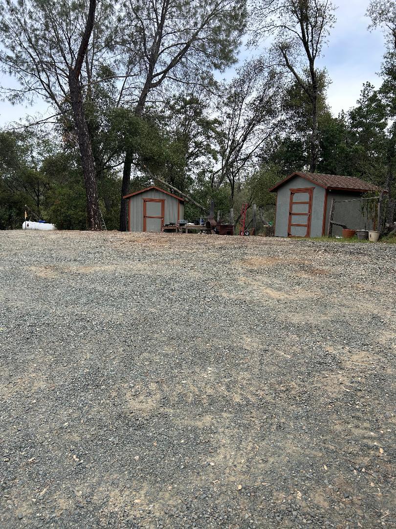 12900 New York Ranch Road Jackson, CA 95642 - Photo 22 of 31 a big room with trees and a wooden fence
