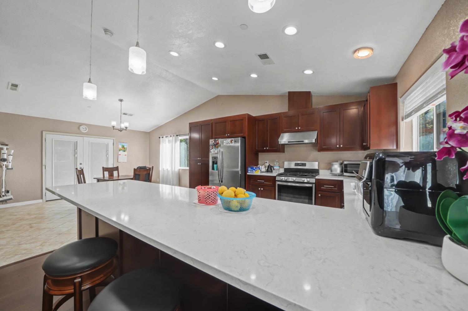 12900 New York Ranch Road Jackson, CA 95642 - Photo 5 of 31 a kitchen with a sink a stove and chairs