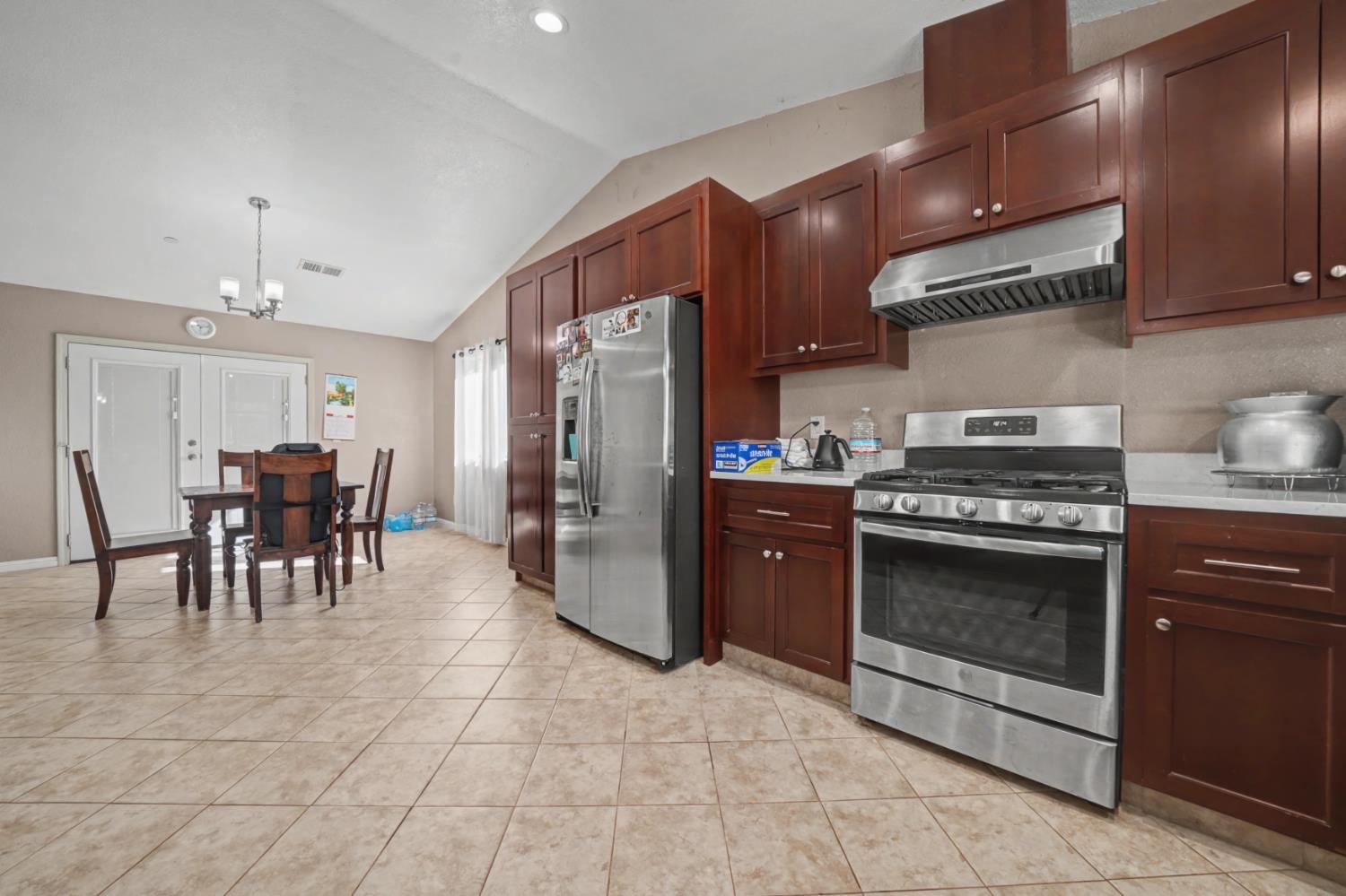 12900 New York Ranch Road Jackson, CA 95642 - Photo 10 of 31 a kitchen with stainless steel appliances granite countertop a stove kitchen island a refrigerator and a stove