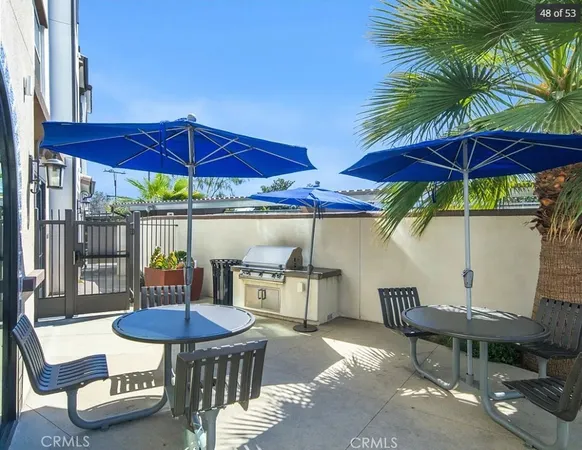 a view of a table and chairs under an umbrella in patio