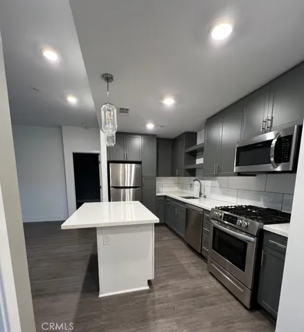 a large kitchen with stainless steel appliances kitchen island a large island in the center