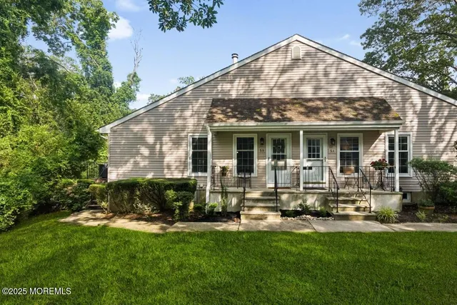 a view of a house with a yard porch and sitting area