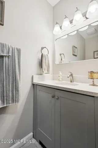 a bathroom with a sink a mirror and vanity