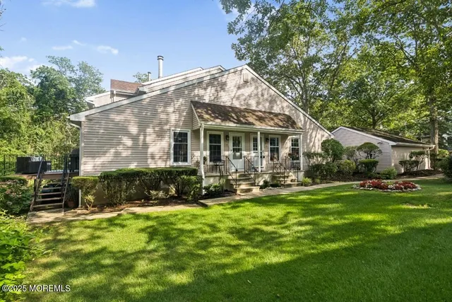 a view of a house with a yard patio and sitting area