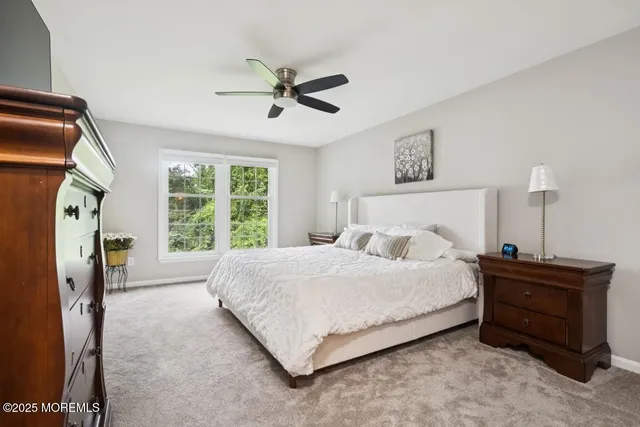 a bedroom with a bed dresser and a window