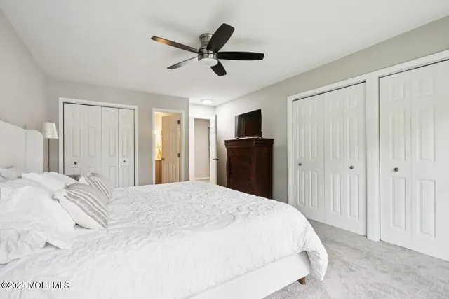 a bedroom with a large bed and a chandelier