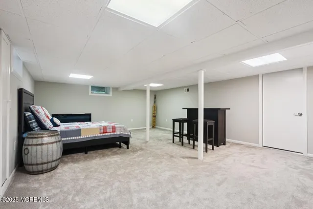 a living room with furniture gym equipment and a ceiling fan