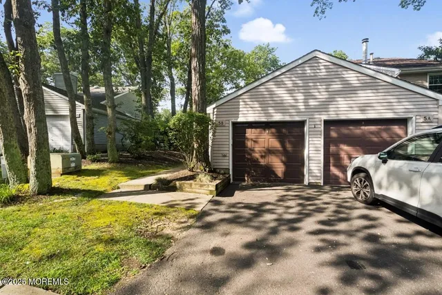a view of a house with swimming pool and sitting area