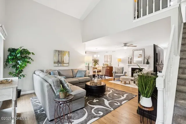 a living room with furniture potted plant and a window